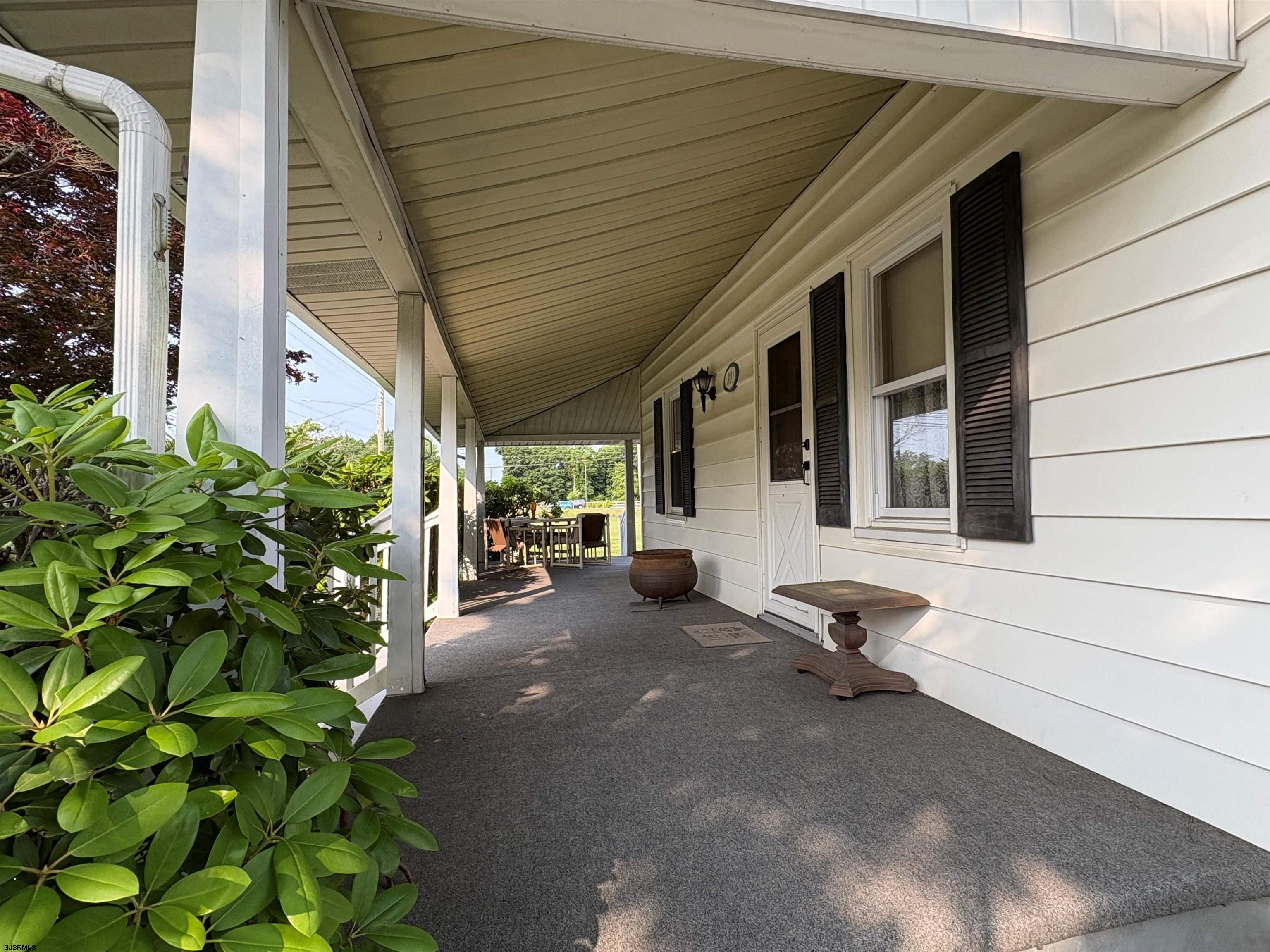 301 Broad Street Milmay, NJ 08330 - Photo 38 of 64 a view of a patio with table and chairs and potted plants
