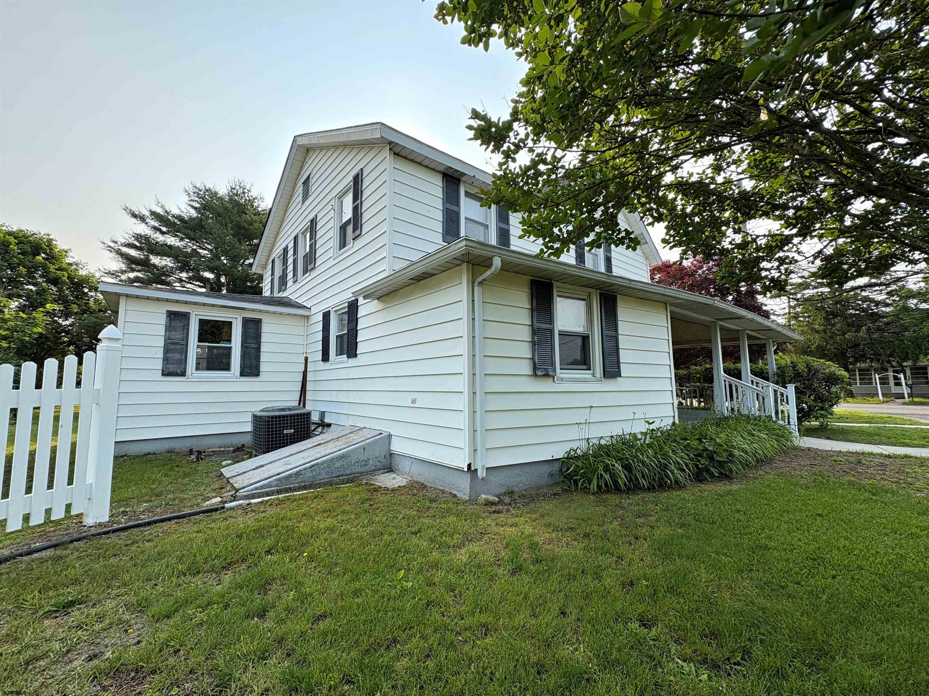 301 Broad Street Milmay, NJ 08330 - Photo 57 of 64 a front view of house with yard and green space