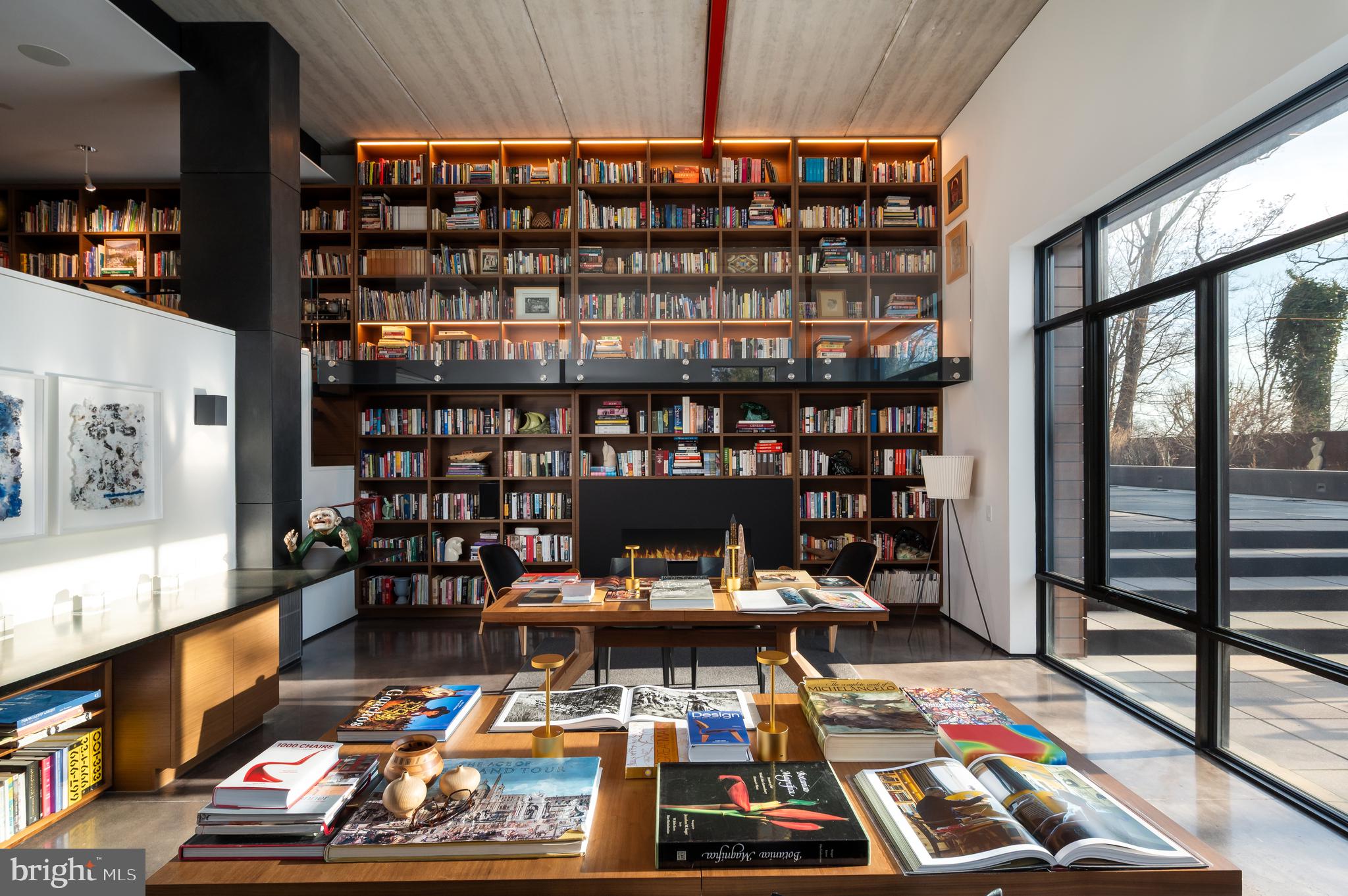 5124 Wissioming Road Bethesda, MD 20816 - Photo 36 of 49 a room with lots of books and a large window