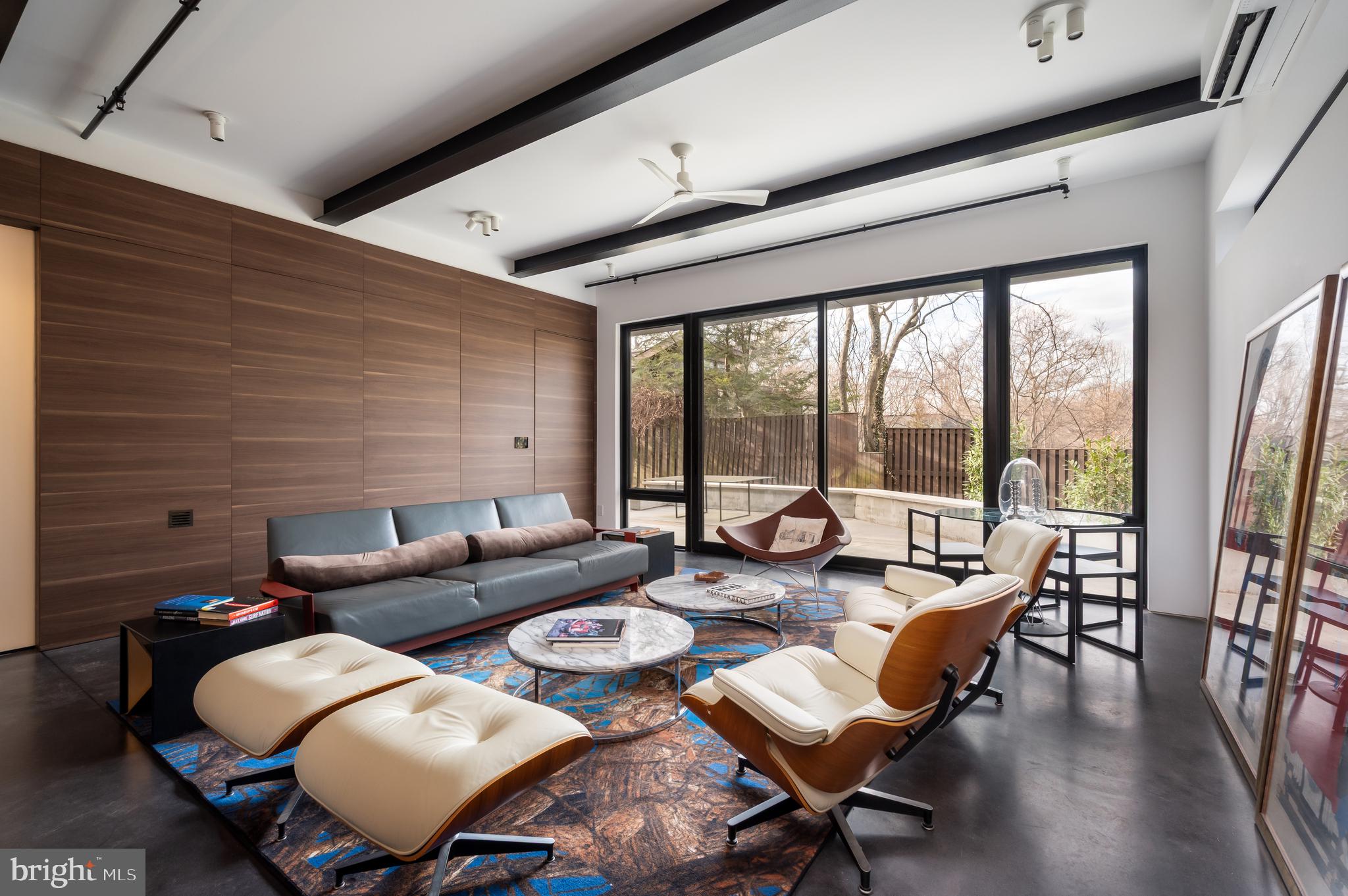 5124 Wissioming Road Bethesda, MD 20816 - Photo 39 of 49 a living room with furniture and a floor to ceiling window