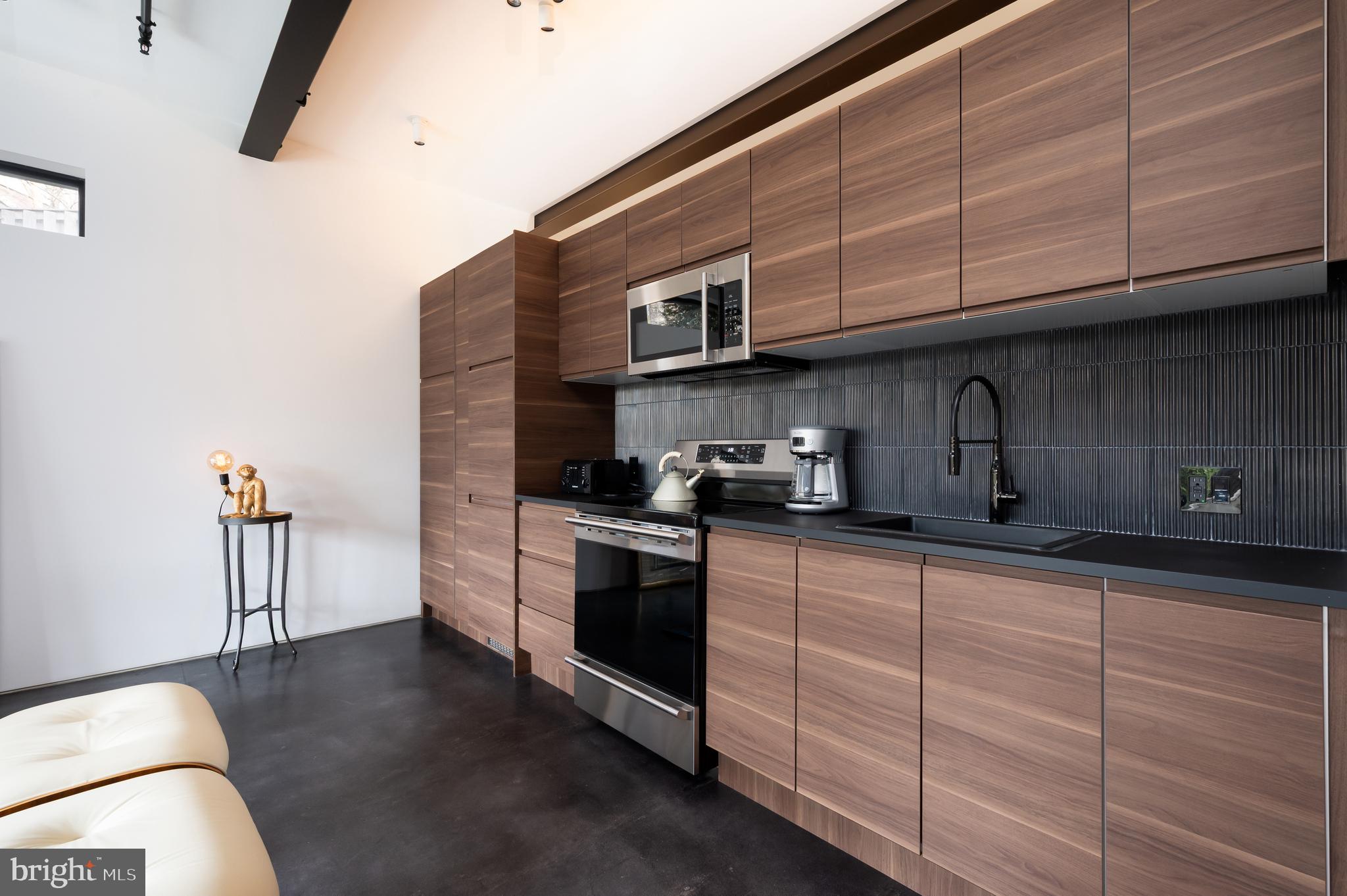 5124 Wissioming Road Bethesda, MD 20816 - Photo 40 of 49 a kitchen with stainless steel appliances granite countertop a sink a stove and cabinets