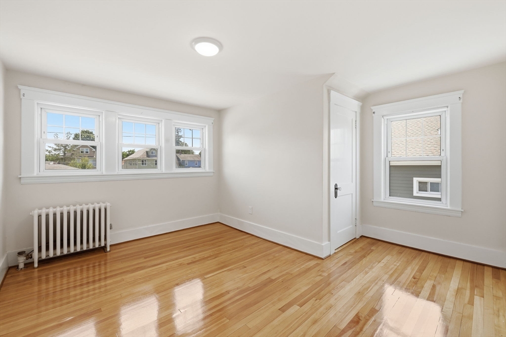 17 Rollinson Road Worcester, MA 01606 - Photo 26 of 41 a view of an empty room with wooden floor and a window