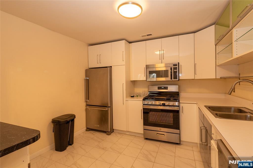 56 Fox Run Drive, Unit 56 Englewood, NJ 07631 - Photo 11 of 31 a kitchen with a refrigerator sink and stove