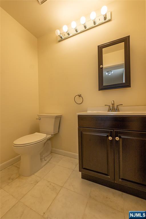 56 Fox Run Drive, Unit 56 Englewood, NJ 07631 - Photo 13 of 31 a bathroom with a sink mirror vanity and toilet