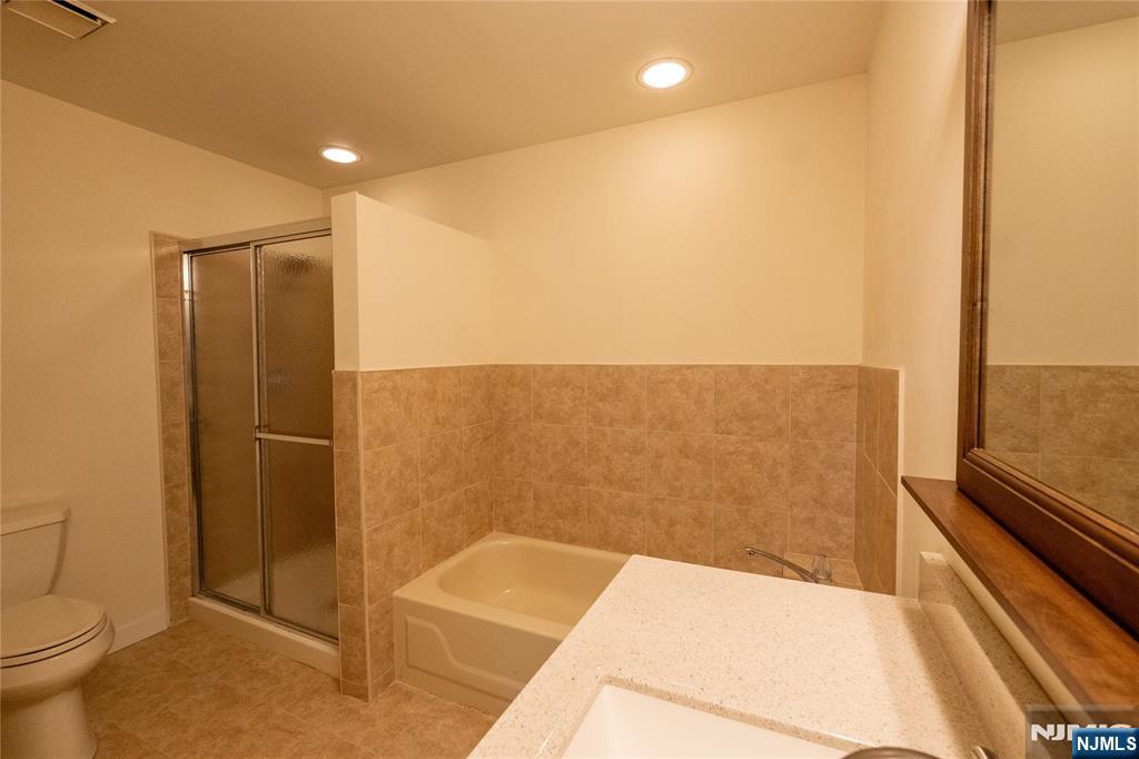 56 Fox Run Drive, Unit 56 Englewood, NJ 07631 - Photo 17 of 31 a bathroom with a bathtub and a toilet