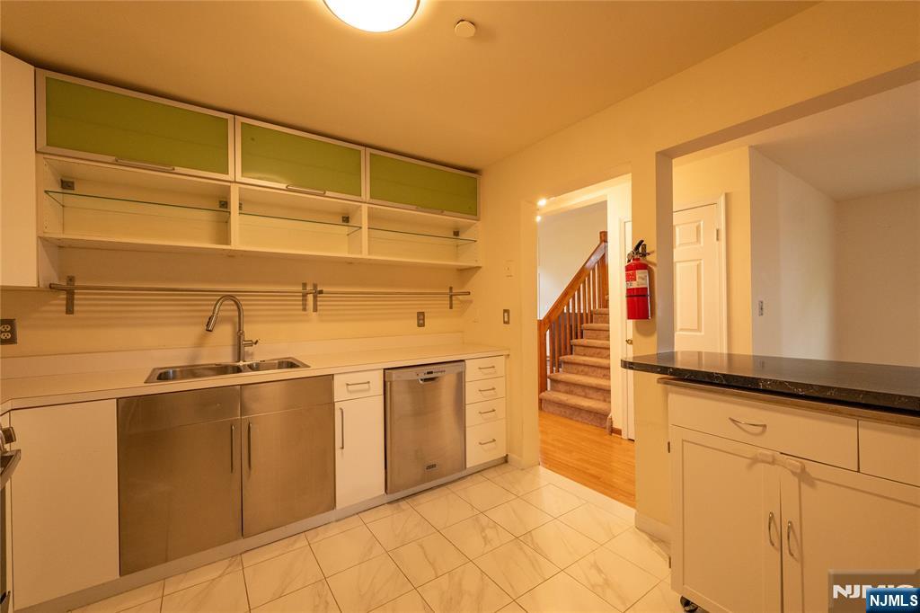 56 Fox Run Drive, Unit 56 Englewood, NJ 07631 - Photo 8 of 31 a kitchen with stainless steel appliances a sink and cabinets