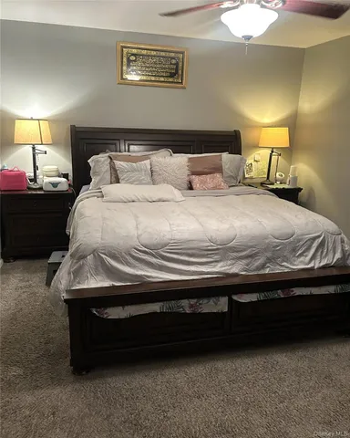 a bedroom with a bed and a lamp