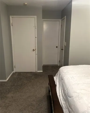 a bedroom with a bed and hallway