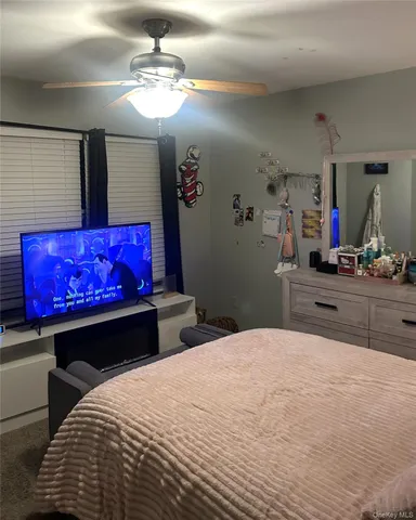 a bedroom with a bed and window