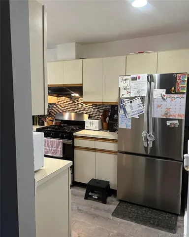 a kitchen with appliances a sink and cabinets