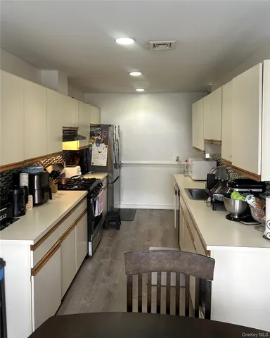 a kitchen that has a lot of cabinets in it and appliances
