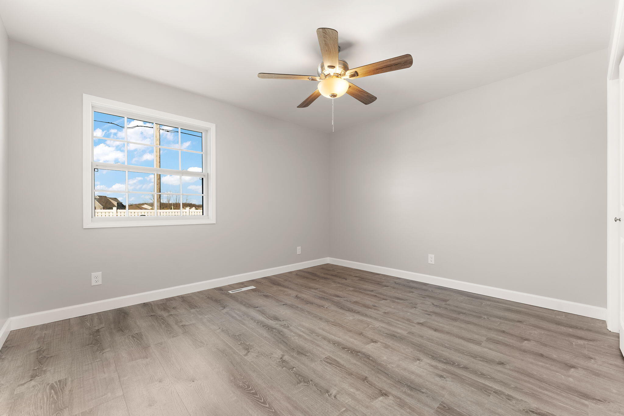 191 Mallard Pointe Drive Valparaiso, IN 46385 - Photo 16 of 25 a view of an empty room with wooden floor and a window