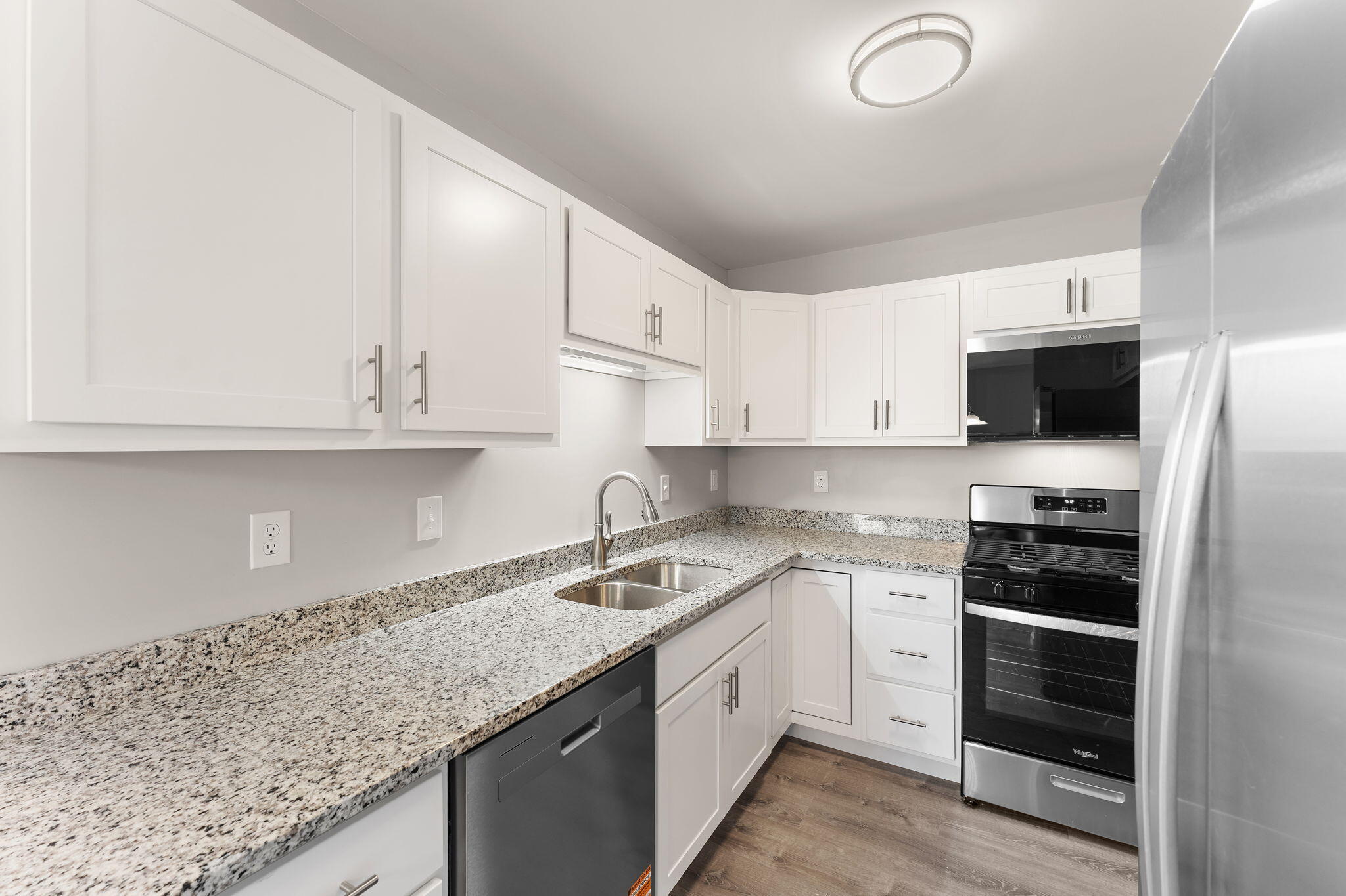 191 Mallard Pointe Drive Valparaiso, IN 46385 - Photo 10 of 25 a kitchen with granite countertop white cabinets and stainless steel appliances
