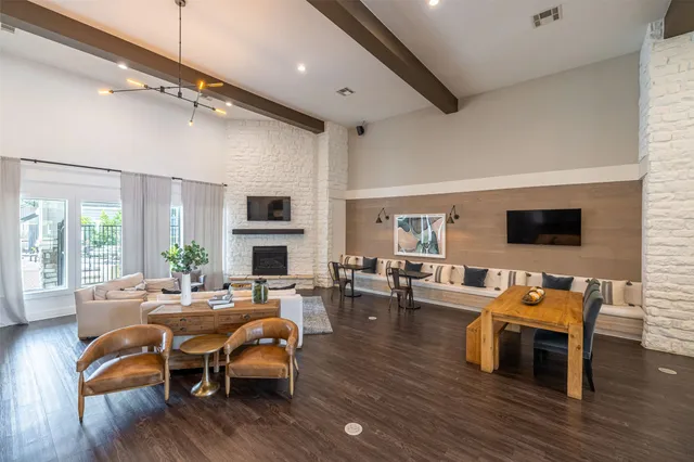 a living room with fireplace furniture and a wooden floor