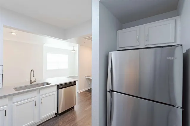 a kitchen with a refrigerator and a sink