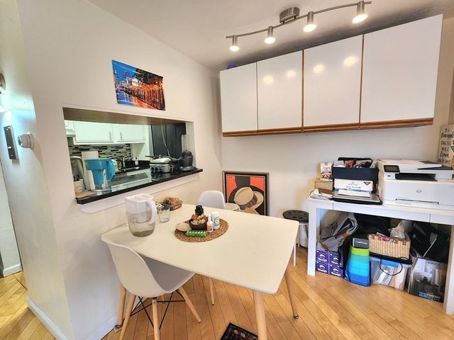 a kitchen with a table and cabinets