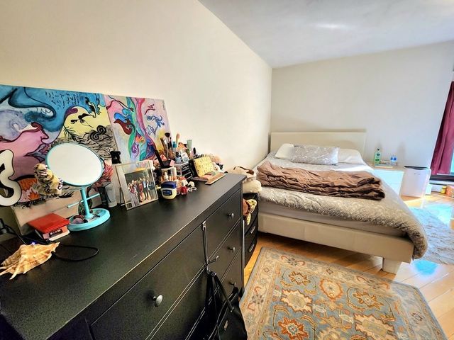 a bedroom with a bed and dresser