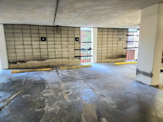 a view of empty room with wooden floor and gym equipment