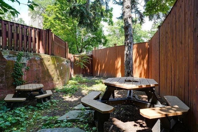 a backyard of a house with table and chairs