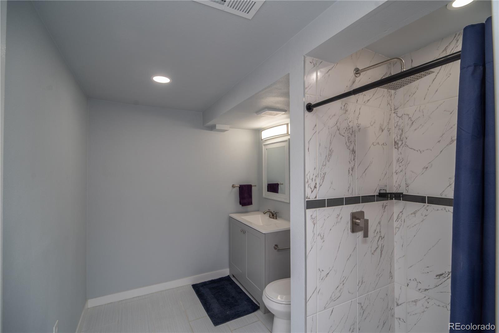 10879 West 65th Way Arvada, CO 80004 - Photo 14 of 41 a bathroom with a sink toilet and shower