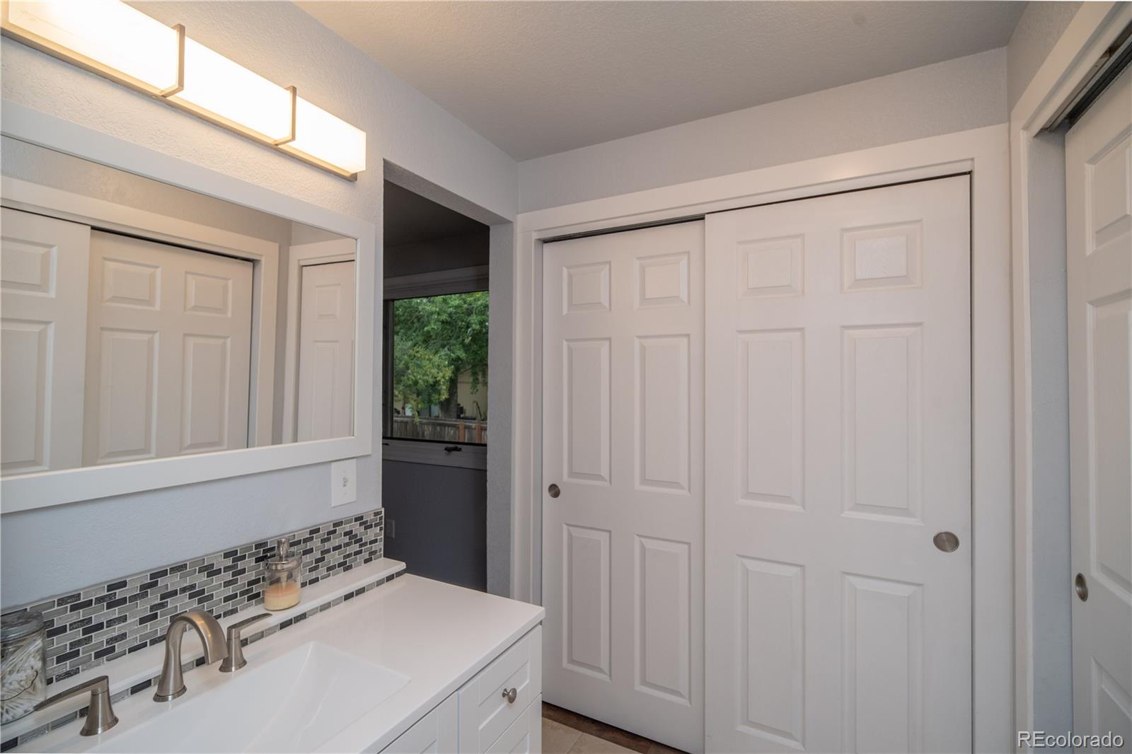 10879 West 65th Way Arvada, CO 80004 - Photo 21 of 41 a bathroom with a sink and a mirror