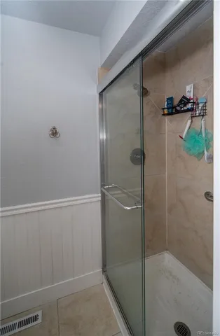 a bathroom with a shower and a sink