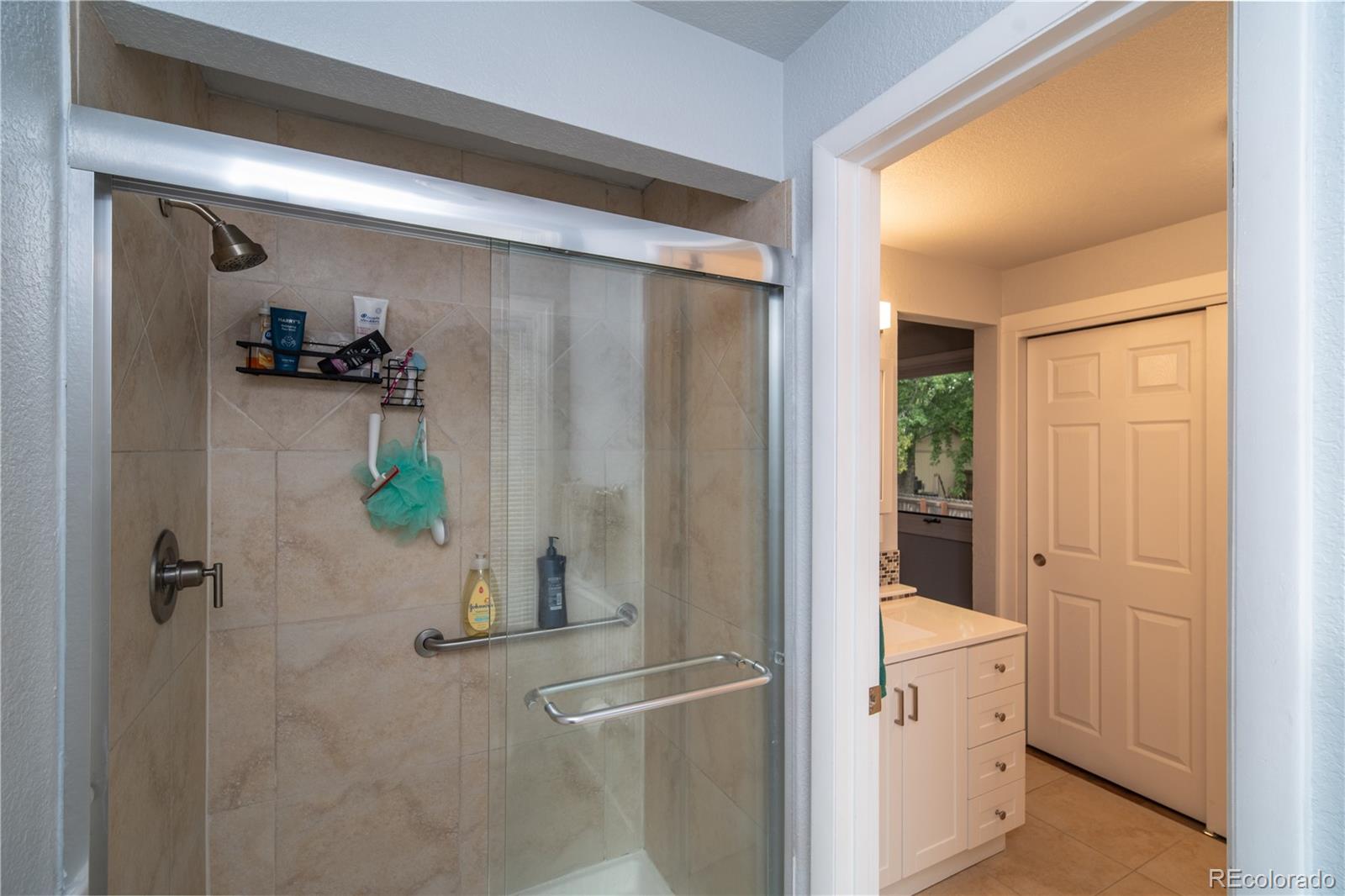 10879 West 65th Way Arvada, CO 80004 - Photo 23 of 41 a bathroom with a shower and a sink