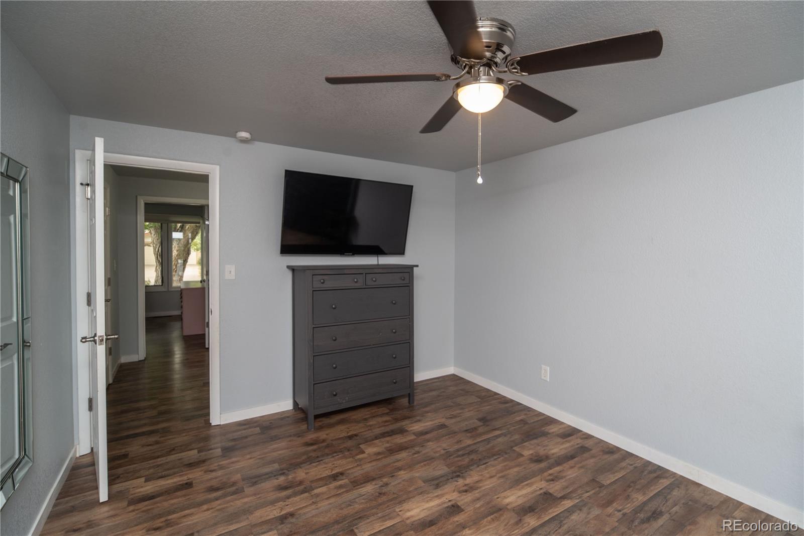10879 West 65th Way Arvada, CO 80004 - Photo 24 of 41 wooden floor in an empty room with a fireplace