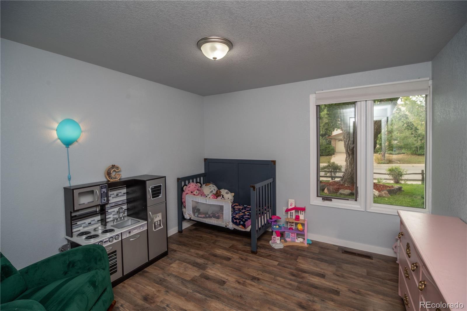 10879 West 65th Way Arvada, CO 80004 - Photo 27 of 41 a living room with furniture and a wooden floor