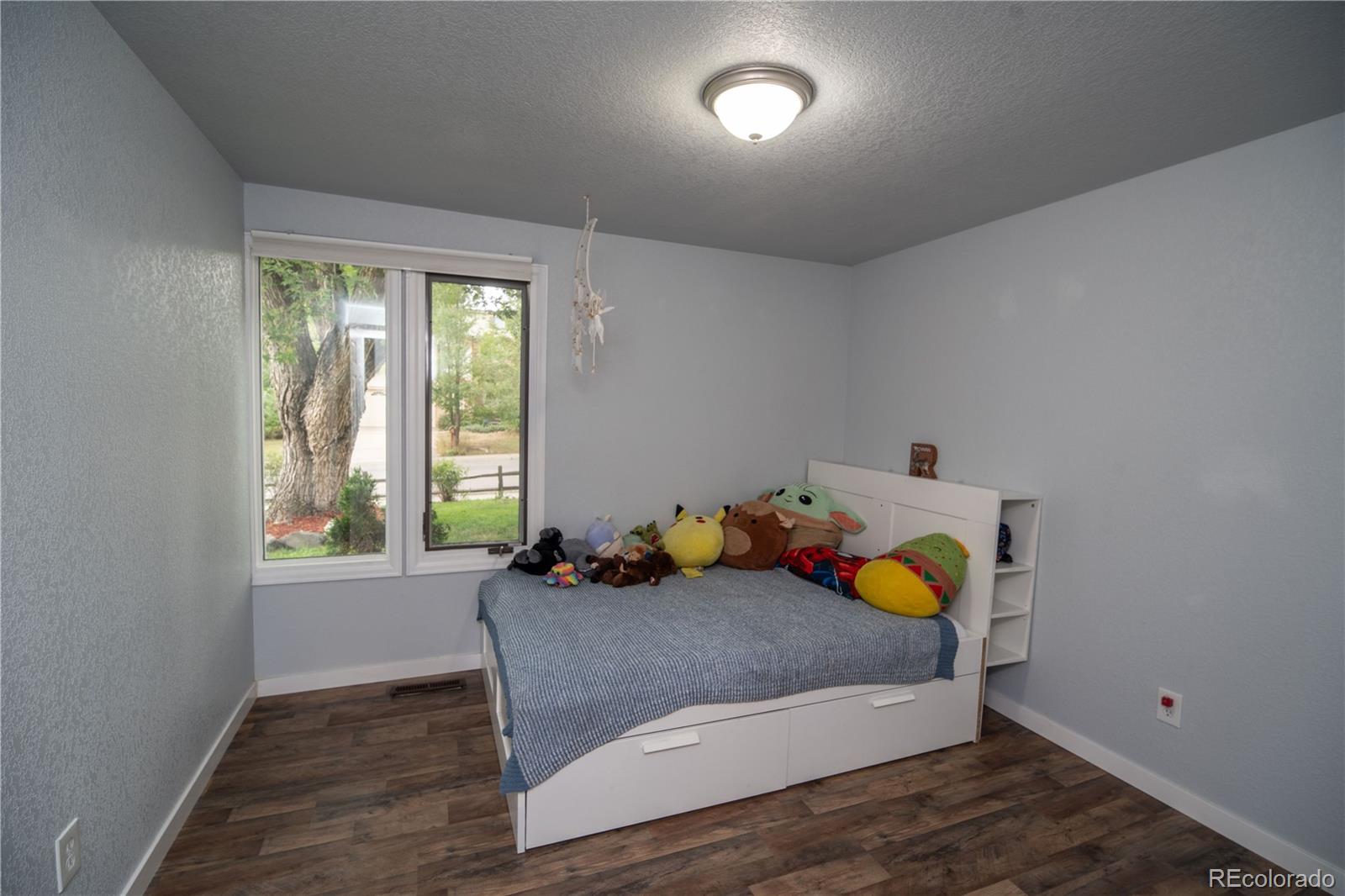 10879 West 65th Way Arvada, CO 80004 - Photo 29 of 41 a bedroom with furniture and window