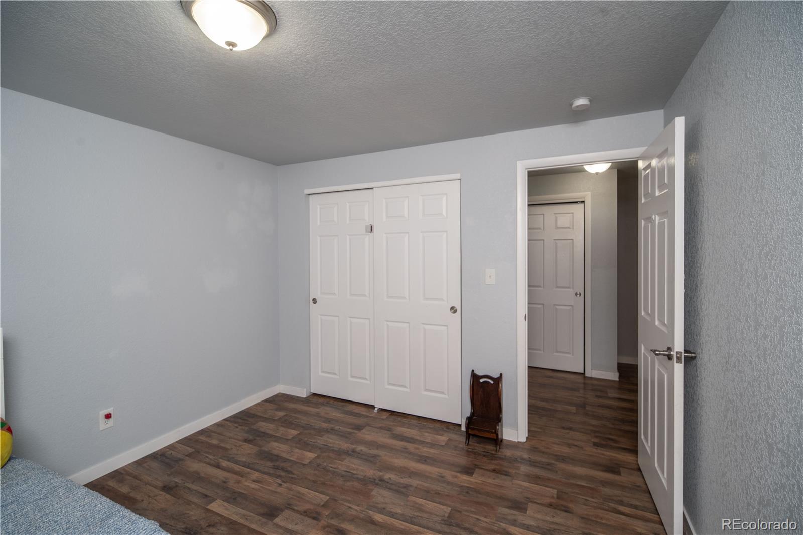 10879 West 65th Way Arvada, CO 80004 - Photo 31 of 41 a view of a room with wooden floor