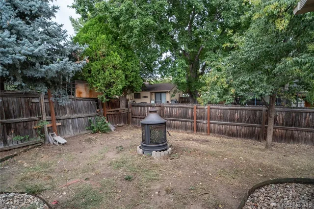 a view of a chair and table in backyard