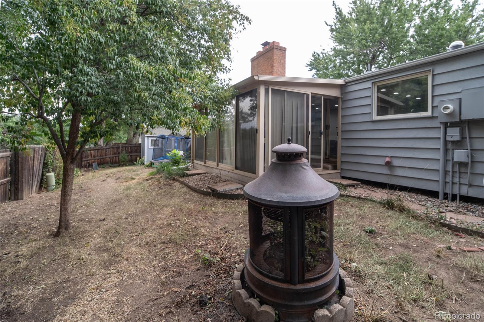 10879 West 65th Way Arvada, CO 80004 - Photo 37 of 41 a view of a chair and table in backyard