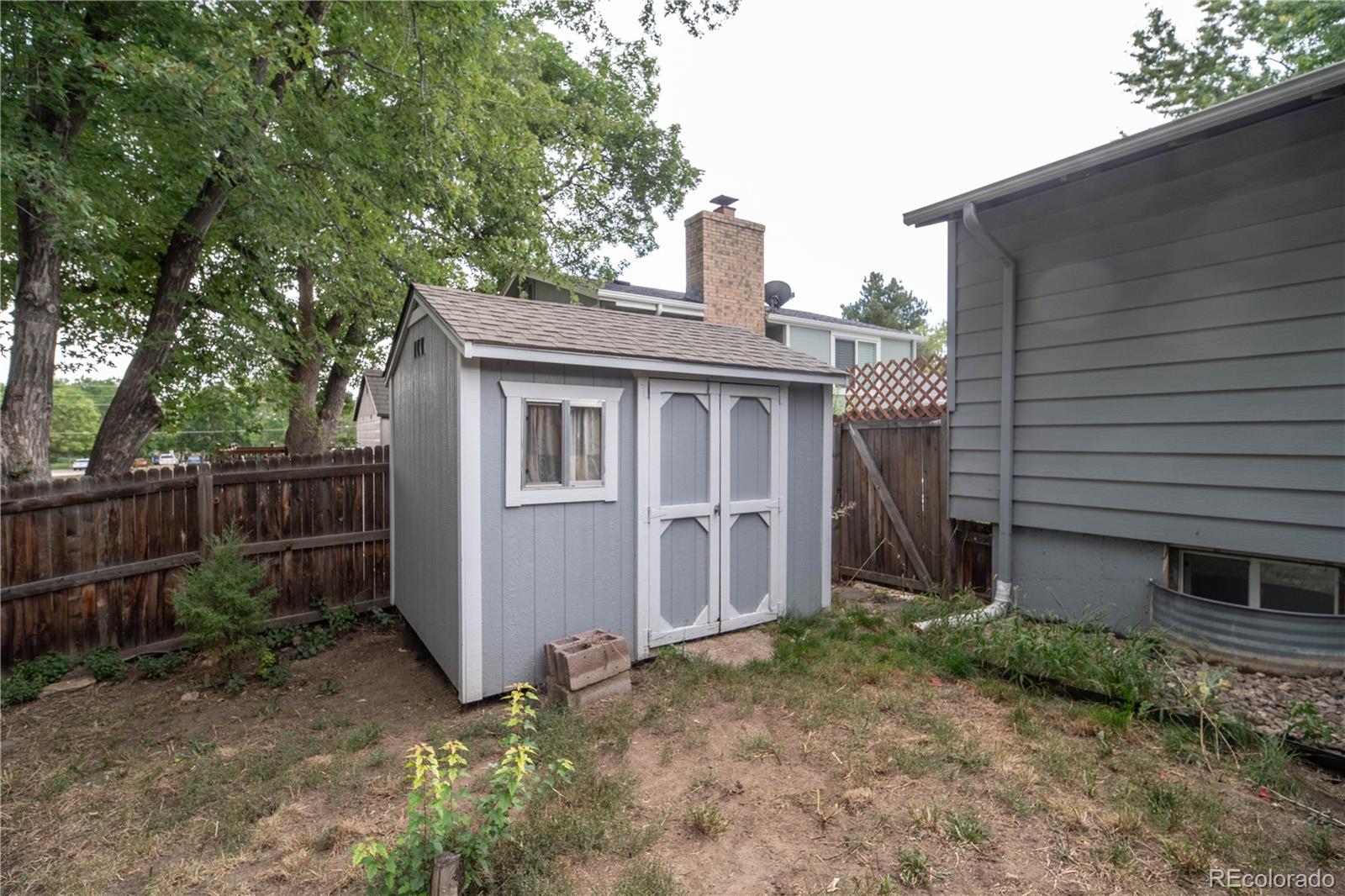 10879 West 65th Way Arvada, CO 80004 - Photo 39 of 41 a view of a house with a backyard