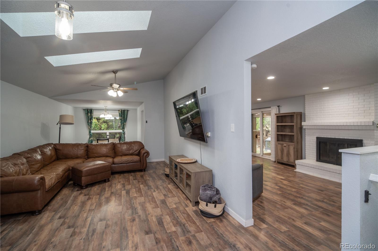 10879 West 65th Way Arvada, CO 80004 - Photo 4 of 41 a living room with furniture and a flat screen tv