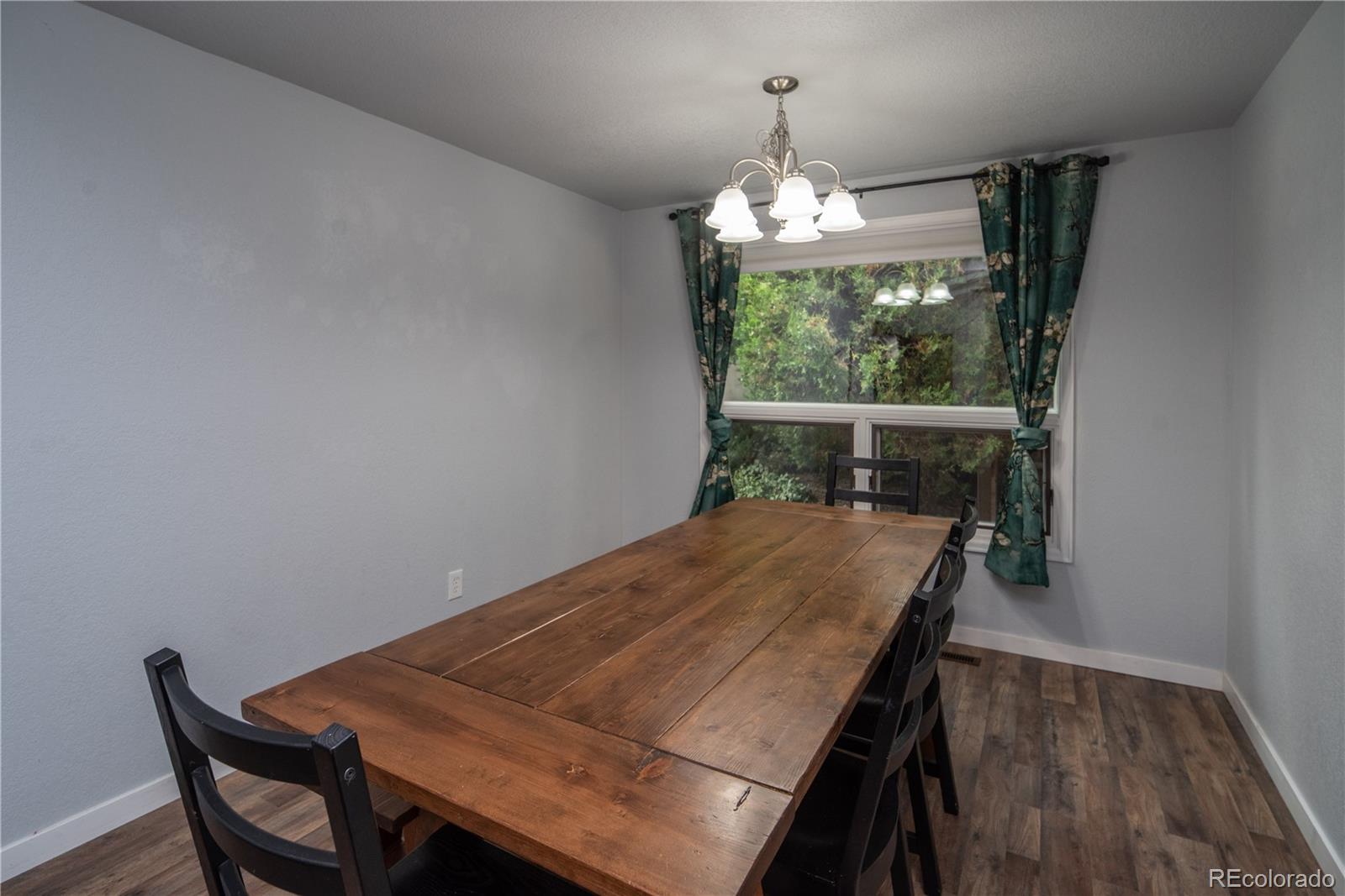 10879 West 65th Way Arvada, CO 80004 - Photo 8 of 41 a view of a dining room with furniture window and wooden floor
