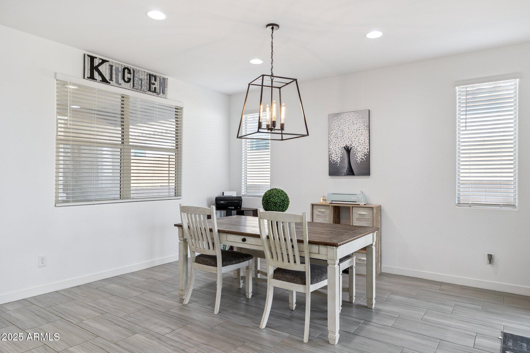 12347 East Soloman Road Gold Canyon, AZ 85118 - Photo 12 of 51 a view of a dining room with furniture wooden floor and chandelier