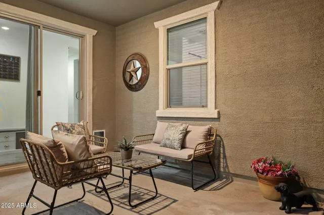 a kitchen with a sink a counter top space and living room view