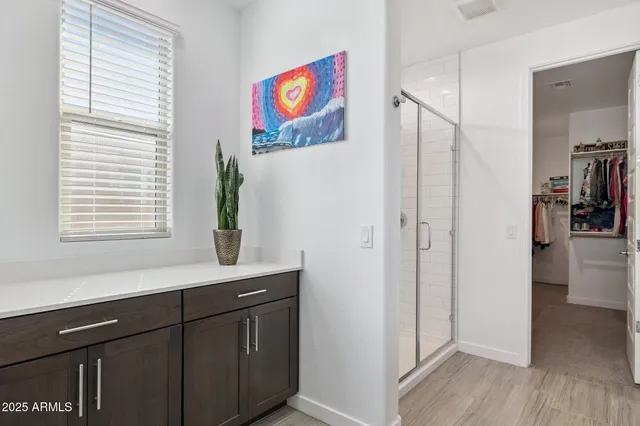 a bathroom with double sink and two mirror