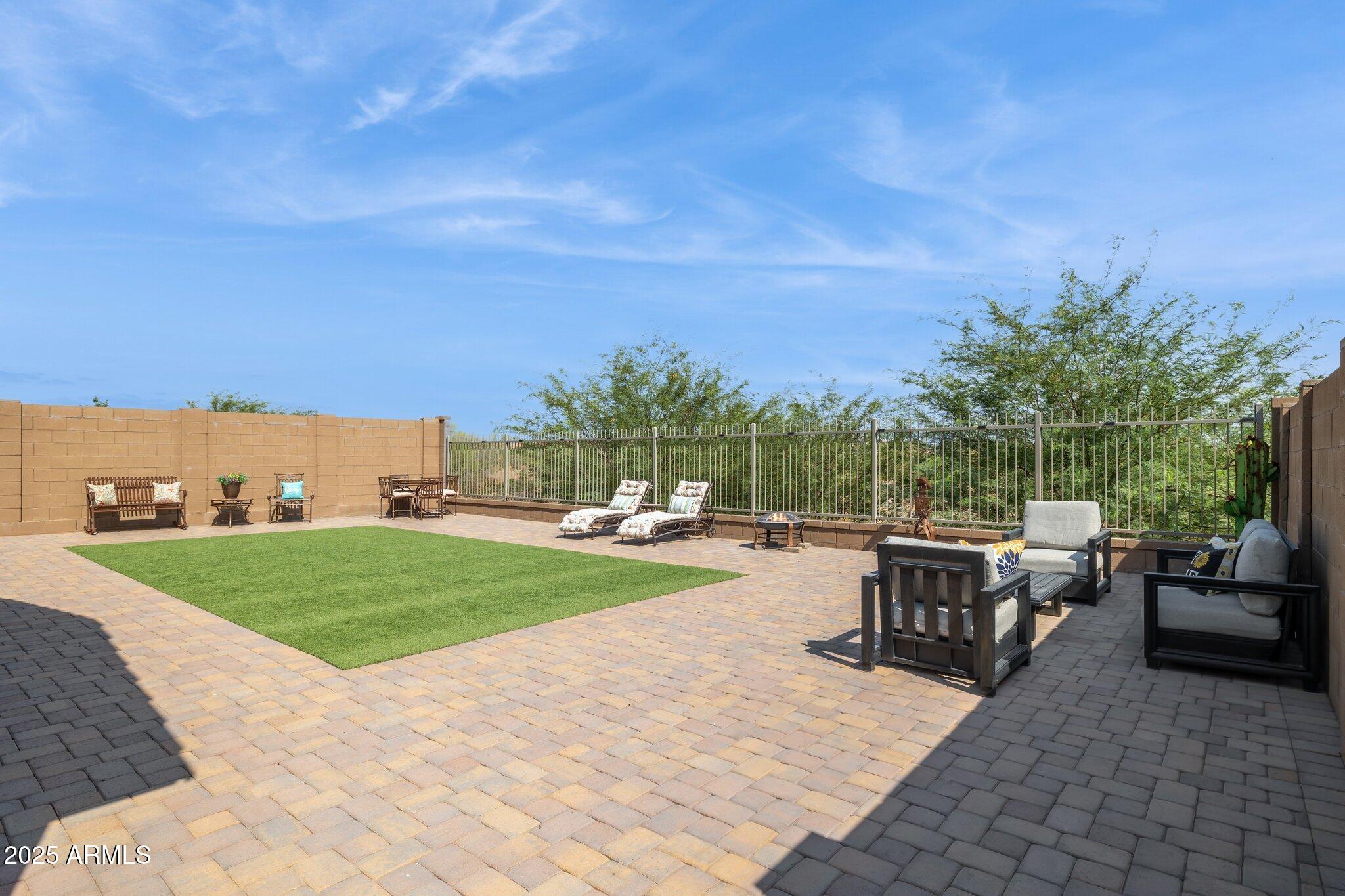 12347 East Soloman Road Gold Canyon, AZ 85118 - Photo 31 of 51 a view of a patio with dining table and chairs with a yard