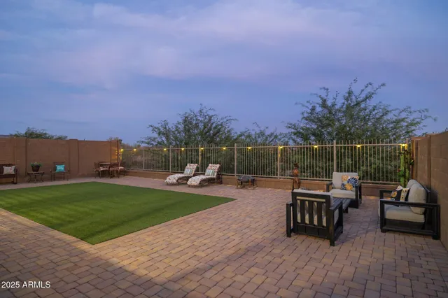 a view of a backyard with sitting area