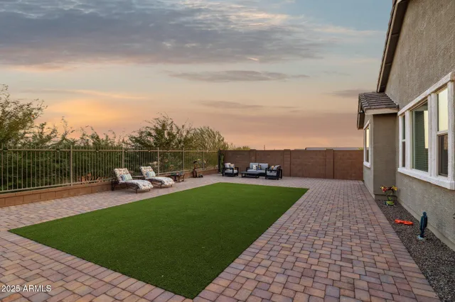 a view of sitting area with furniture and wooden fence