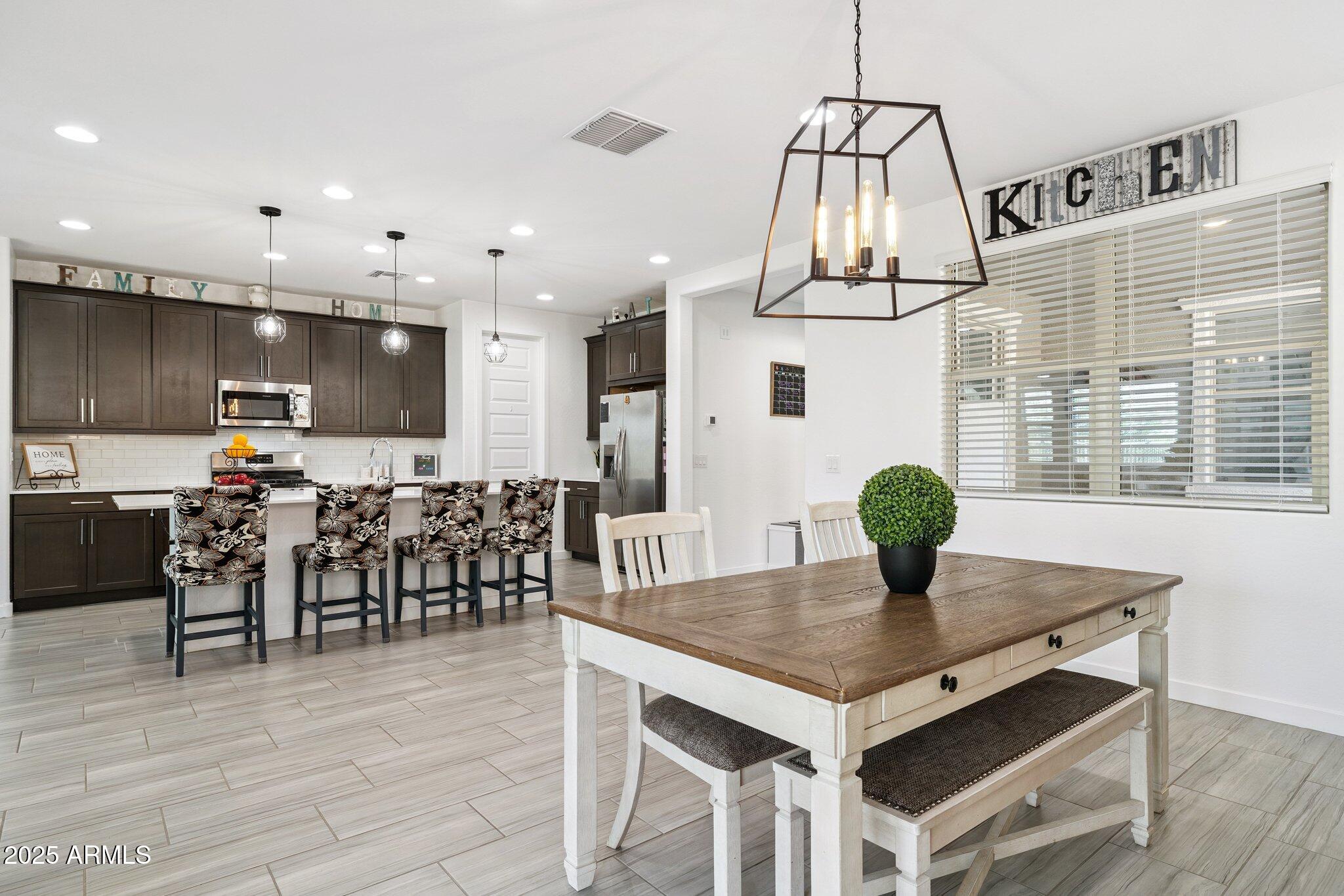 12347 East Soloman Road Gold Canyon, AZ 85118 - Photo 8 of 51 a kitchen with a dining table chairs and wooden floor