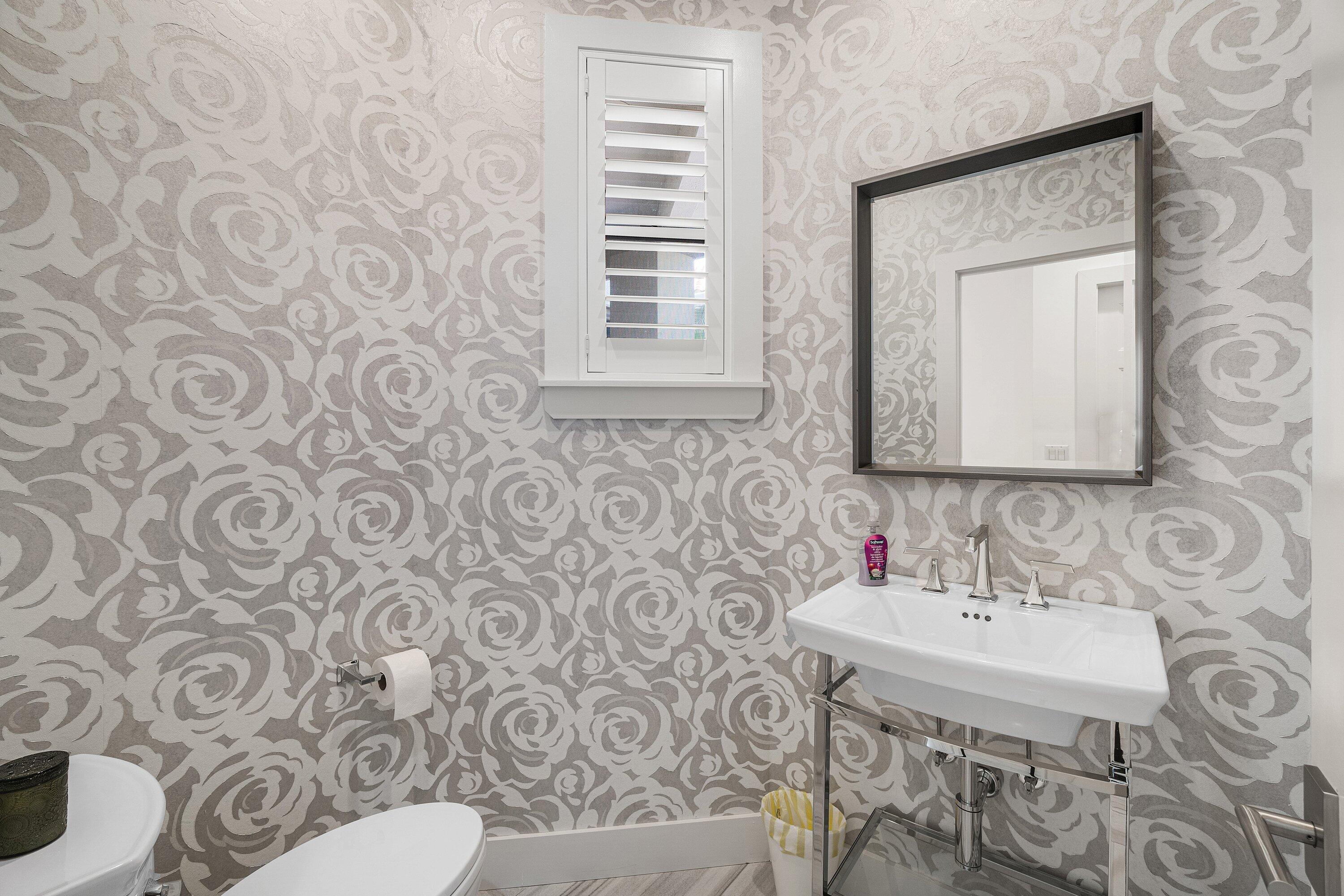 2404 Northwest 67th Street Boca Raton, FL 33496 - Photo 17 of 74 a bathroom with a sink a toilet a mirror and shower curtain