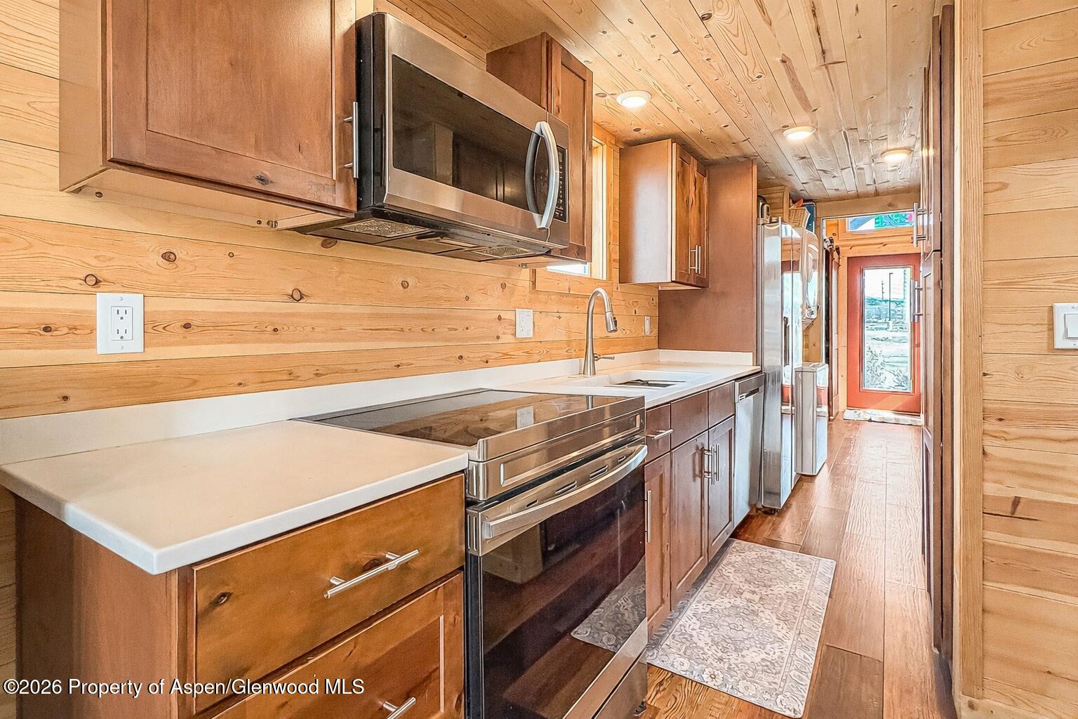 329 River Frontage Road, Unit 44 Silt, CO 81652 - Photo 4 of 17 a kitchen with stainless steel appliances granite countertop a stove and a microwave