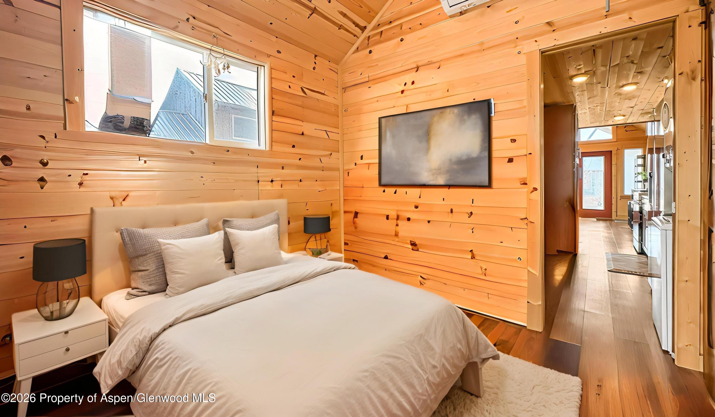 329 River Frontage Road, Unit 44 Silt, CO 81652 - Photo 5 of 17 a bedroom with a bed and wooden floor