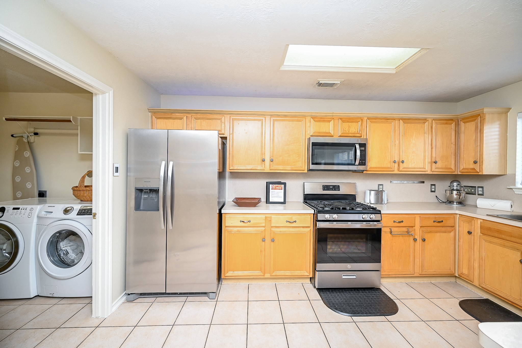 12122 Lucky Meadow Drive Tomball, TX 77375 - Photo 14 of 32 a kitchen with stainless steel appliances granite countertop a stove a sink and a refrigerator