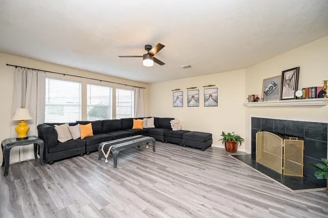 a view of a room with wooden floor and furniture