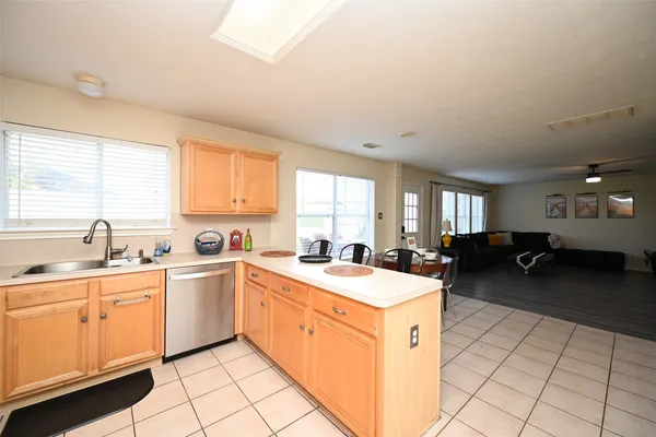 a kitchen that has a sink and a stove in it
