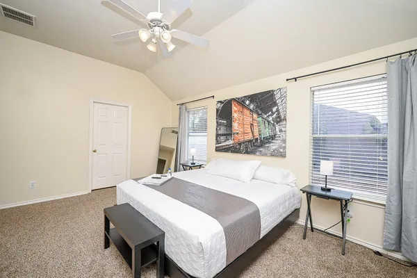 a bedroom with a bed and a chandelier